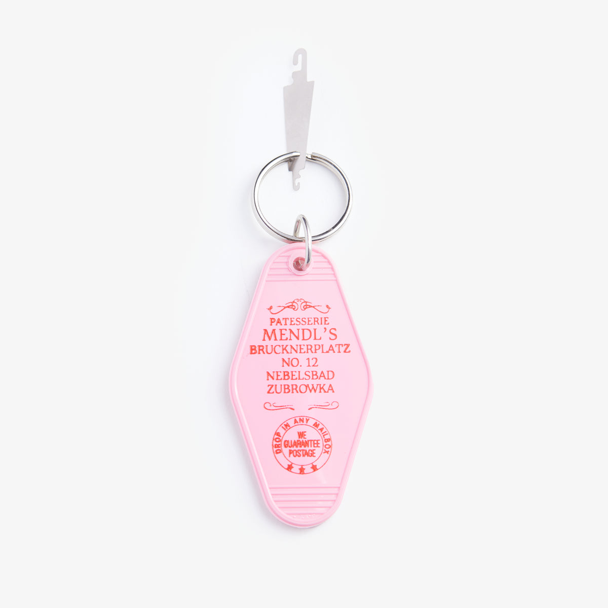 Pink keychain tag with text on a white background
