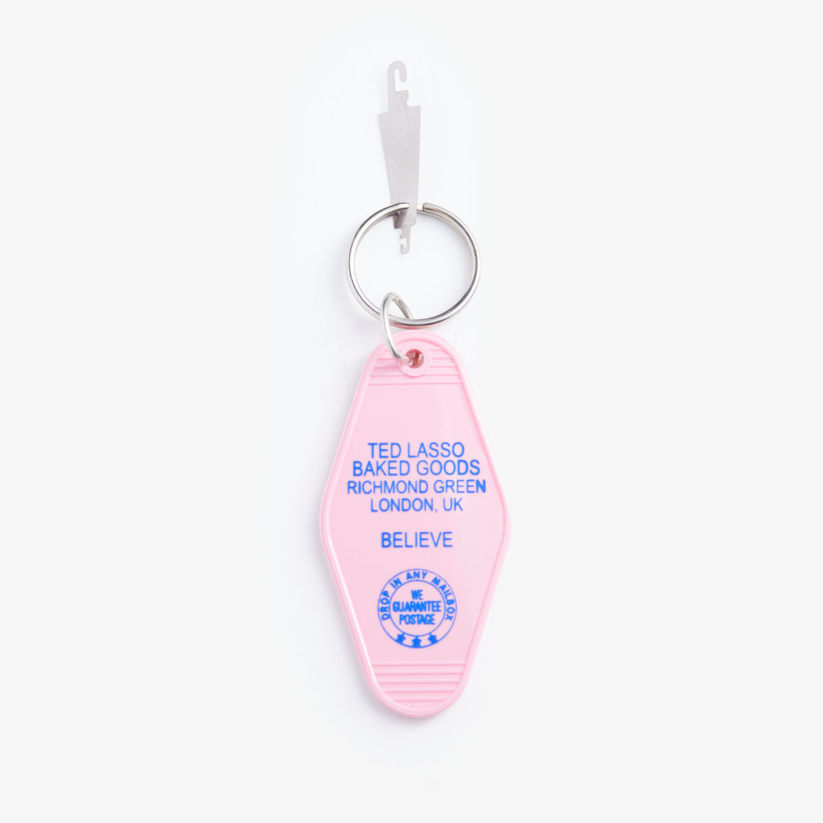 Pink keychain with blue text on a white background