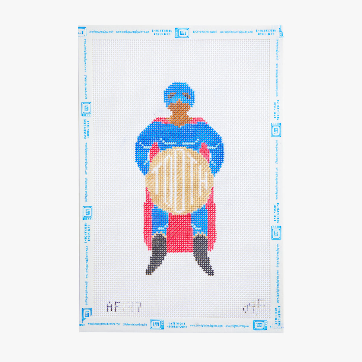 Cross-stitch pattern of a person in superhero costume with cape and mask, holding a shield.