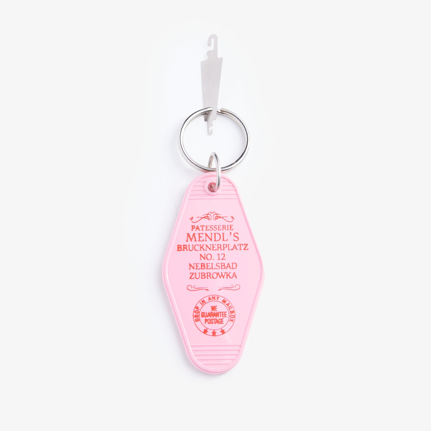 Pink keychain tag with text on a white background