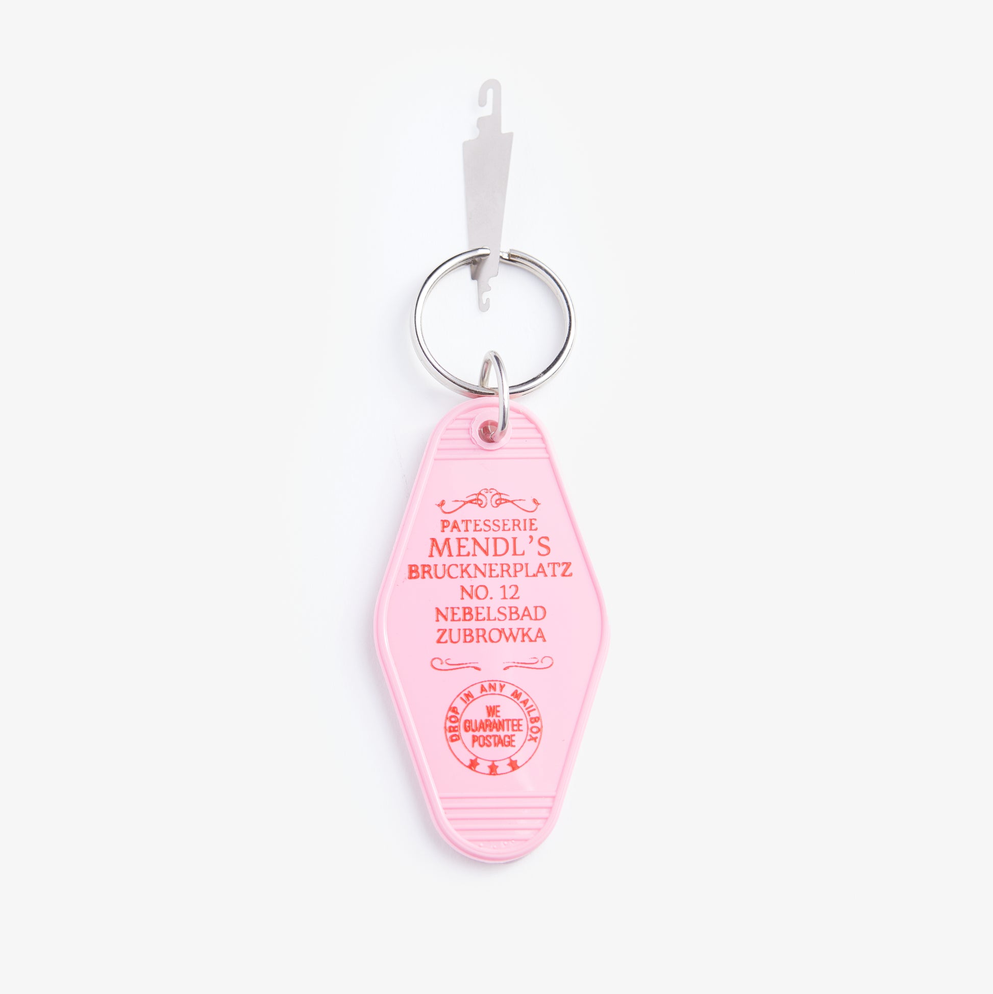 Pink keychain tag with text on a white background