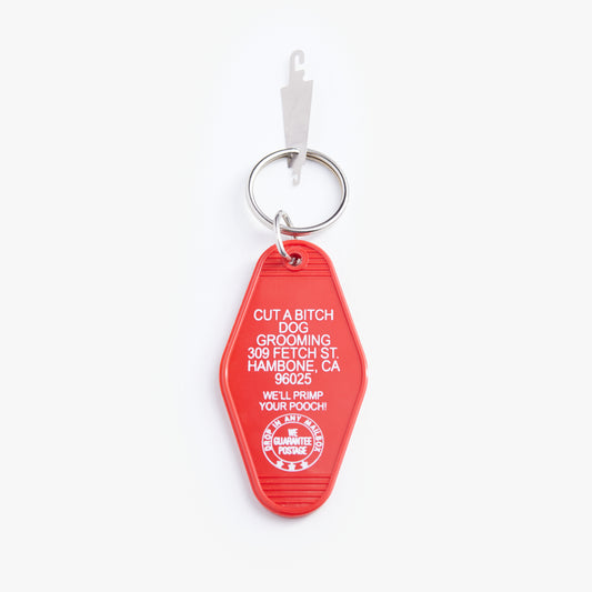 Red keychain with white text on a white background