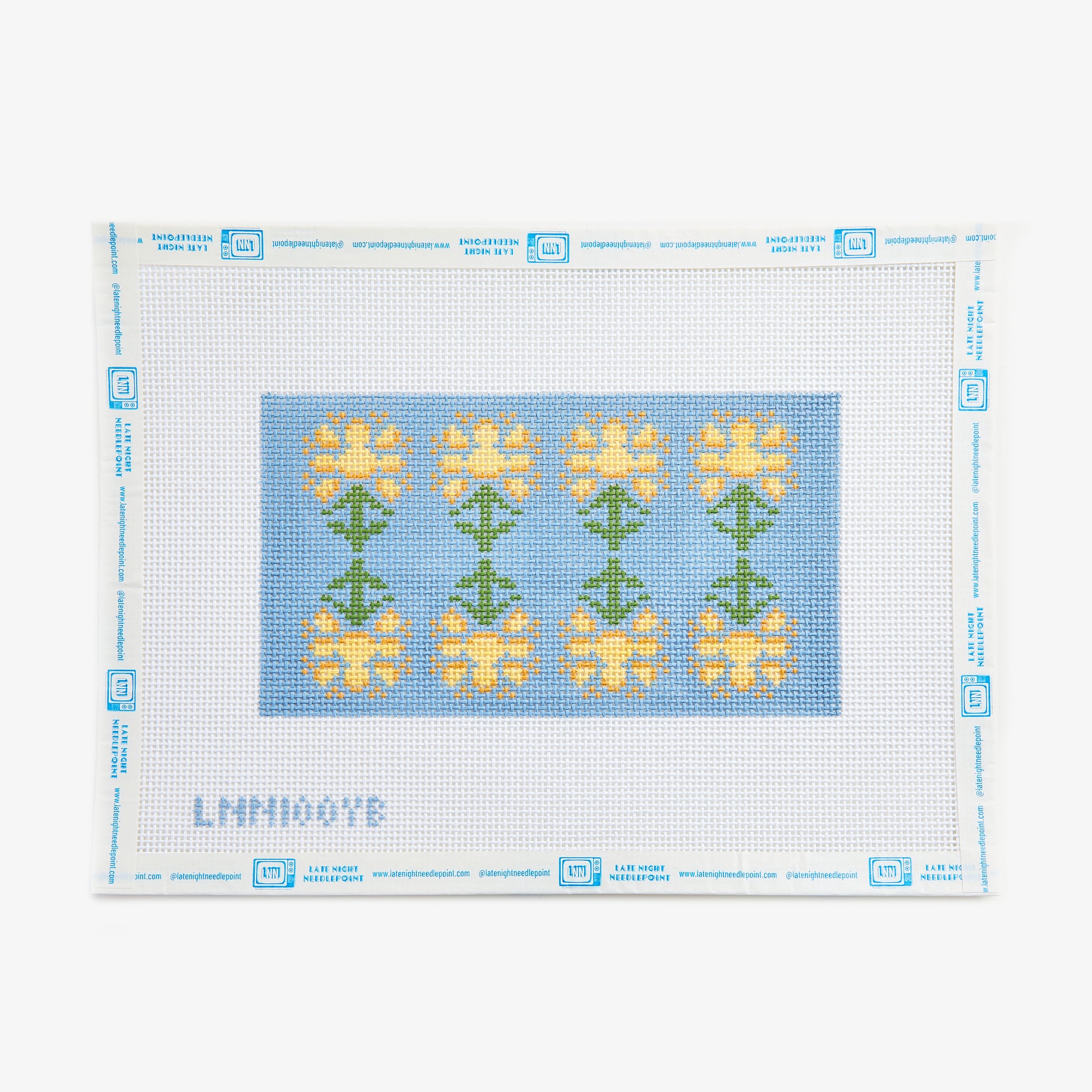 Cross-stitch pattern with yellow flowers on a blue background, framed by a white border.