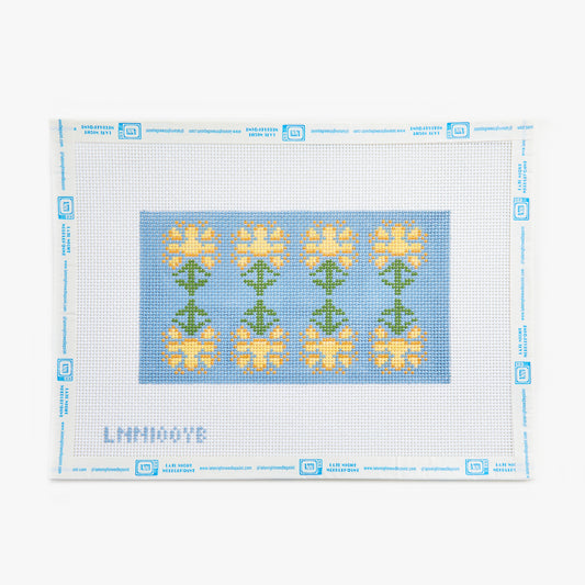 Cross-stitch pattern with yellow flowers on a blue background, framed by a white border.