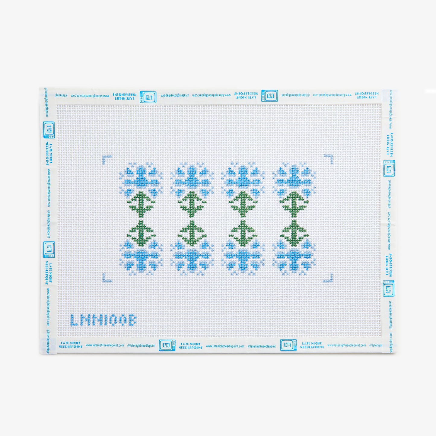 Cross-stitch pattern with green trees and blue flowers on a white background