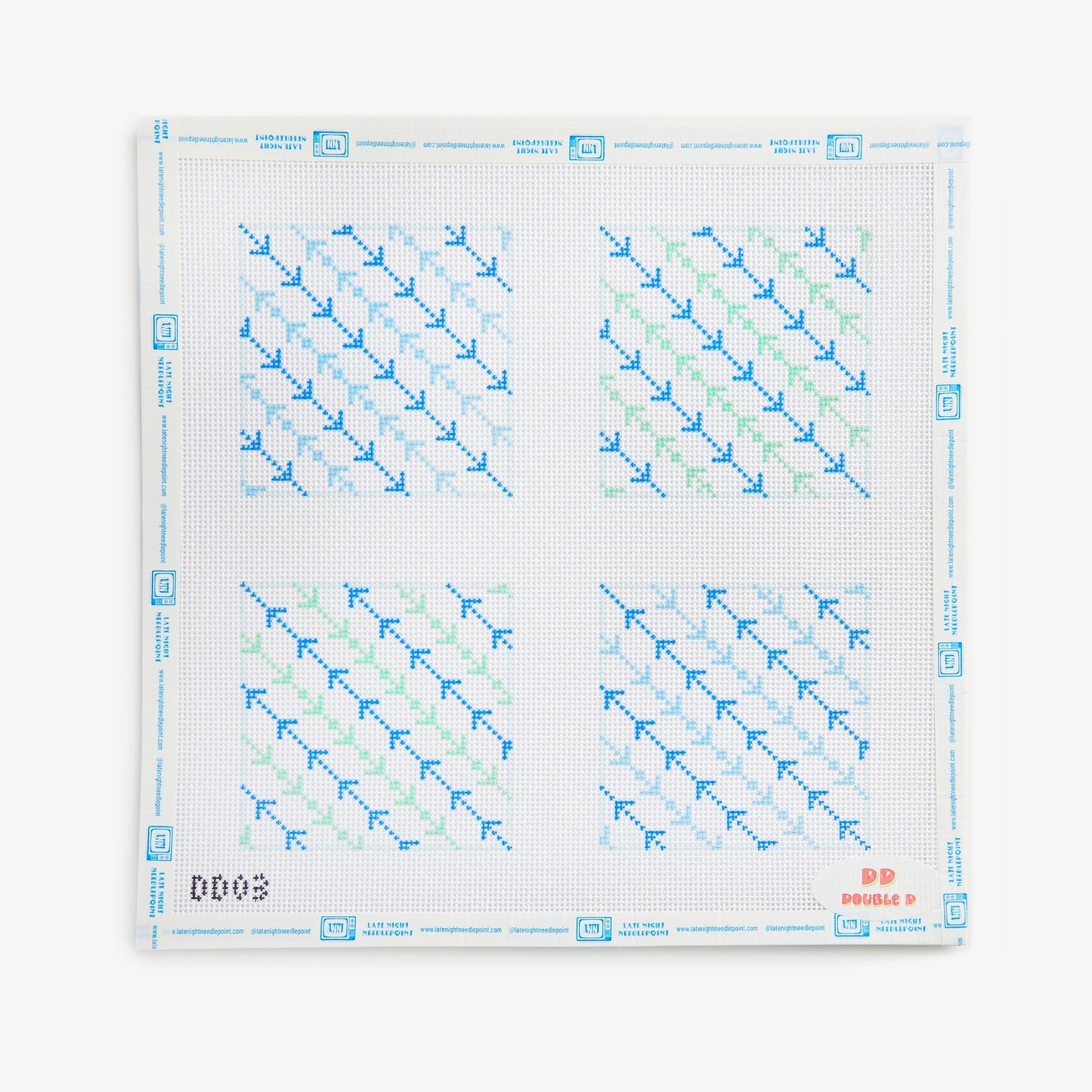 Cross-stitch pattern with blue and green threads on a white background