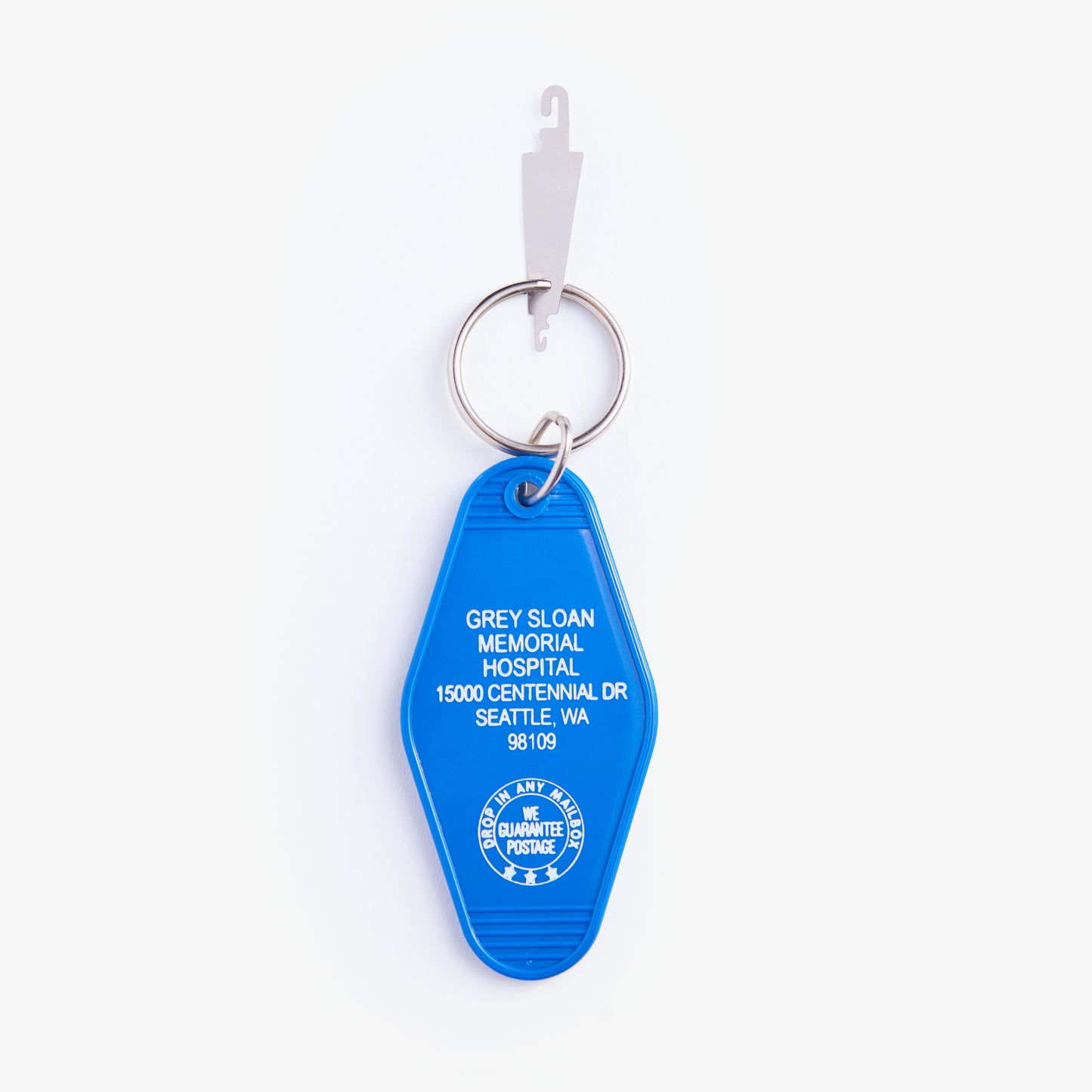 Blue keychain with text on a white background