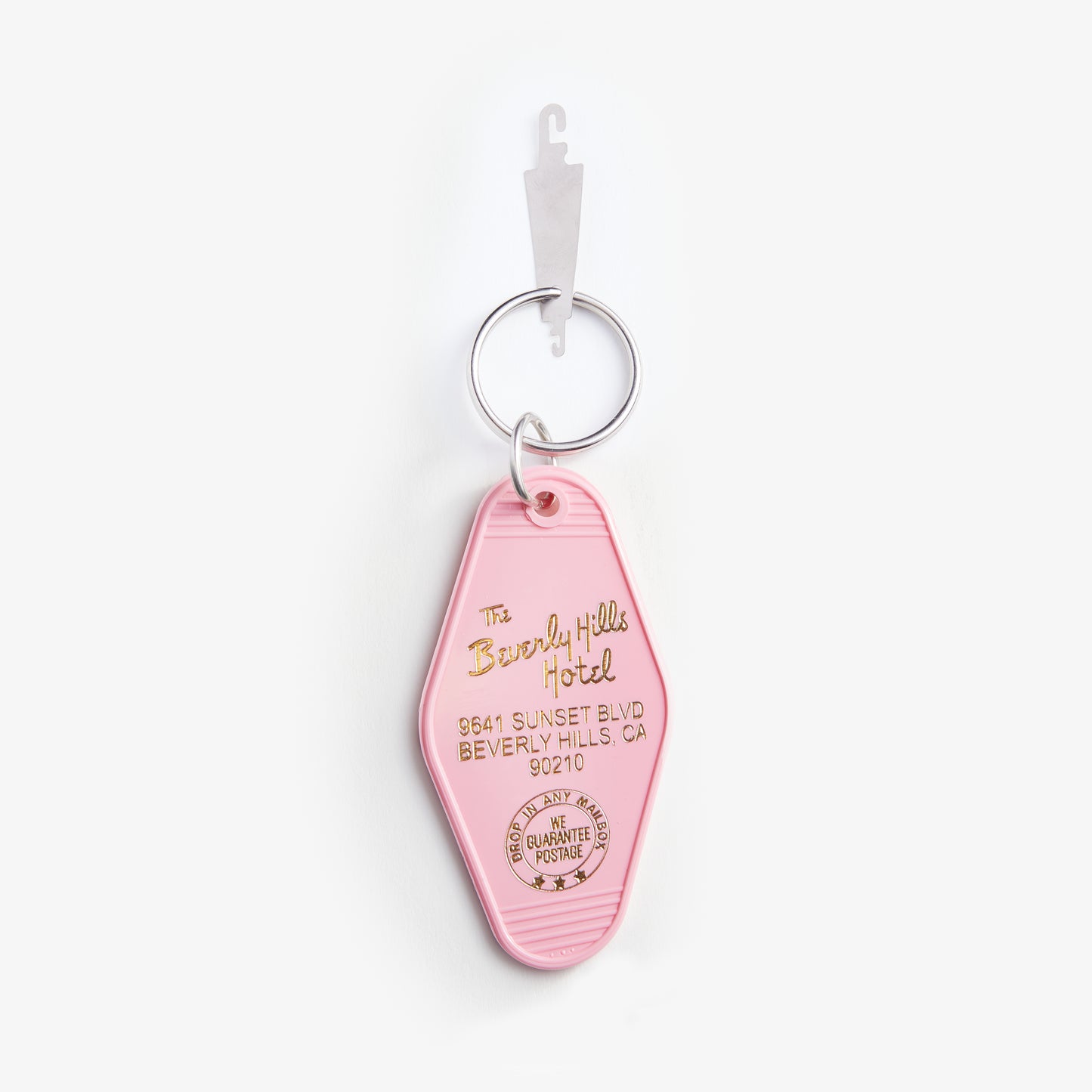 Pink keychain with 'Beverly Hills Hotel' branding on a white background