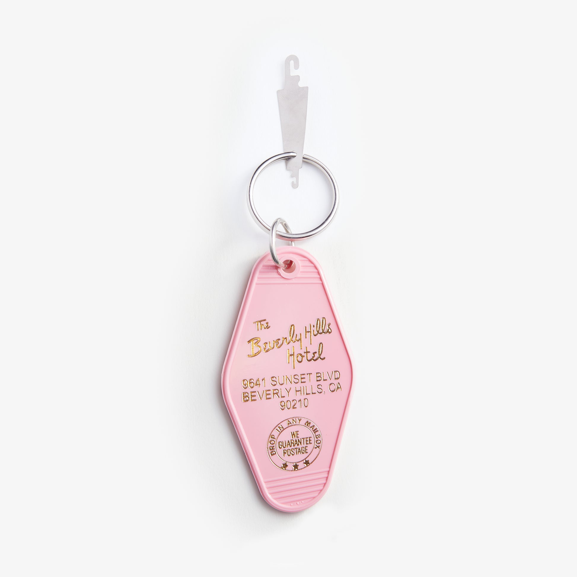 Pink keychain with 'Beverly Hills Hotel' branding on a white background