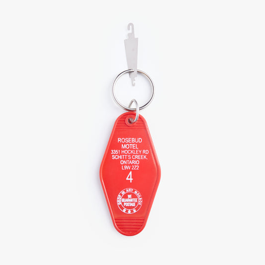 Red motel keychain with white text on a white background