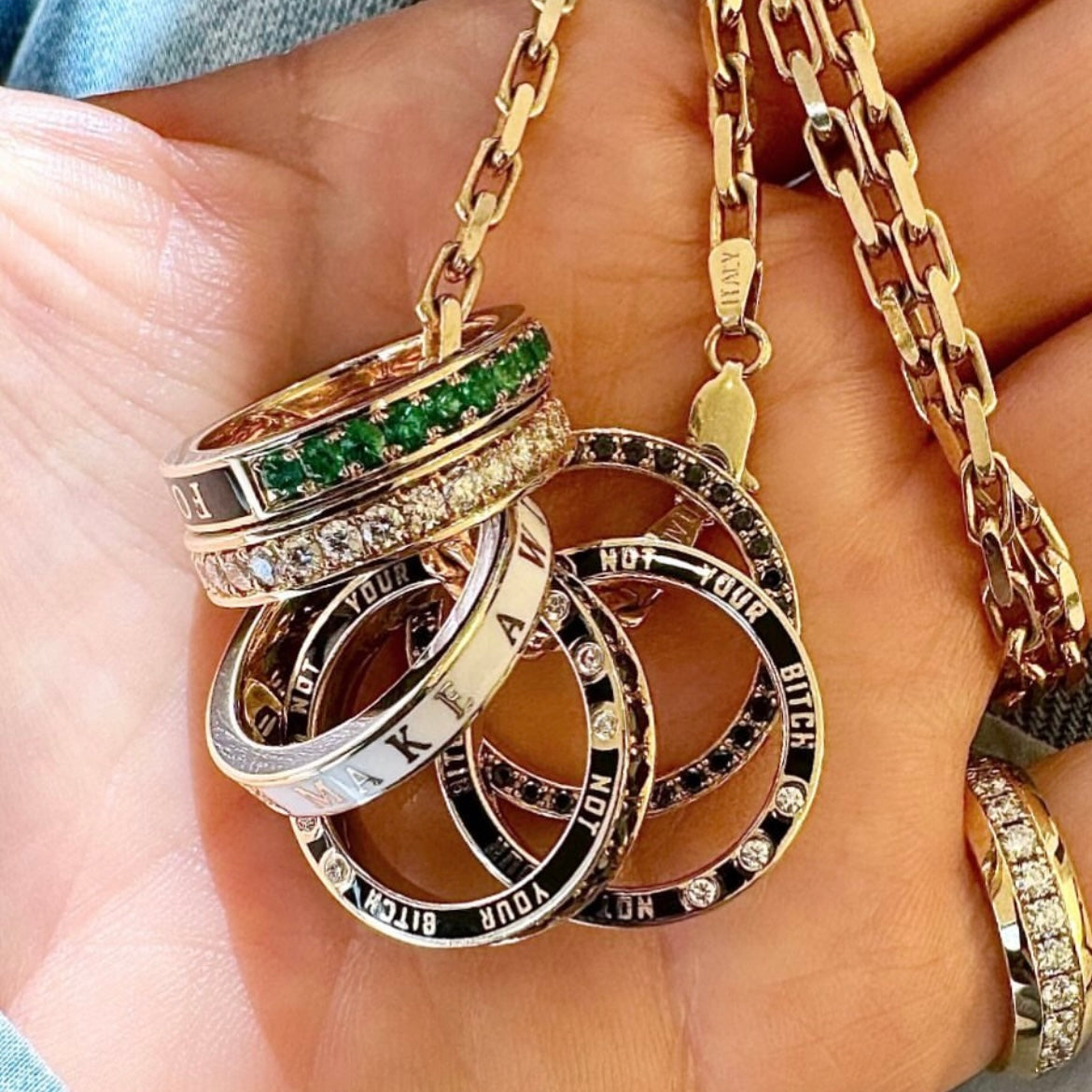 Rings on a chain held by a hand.